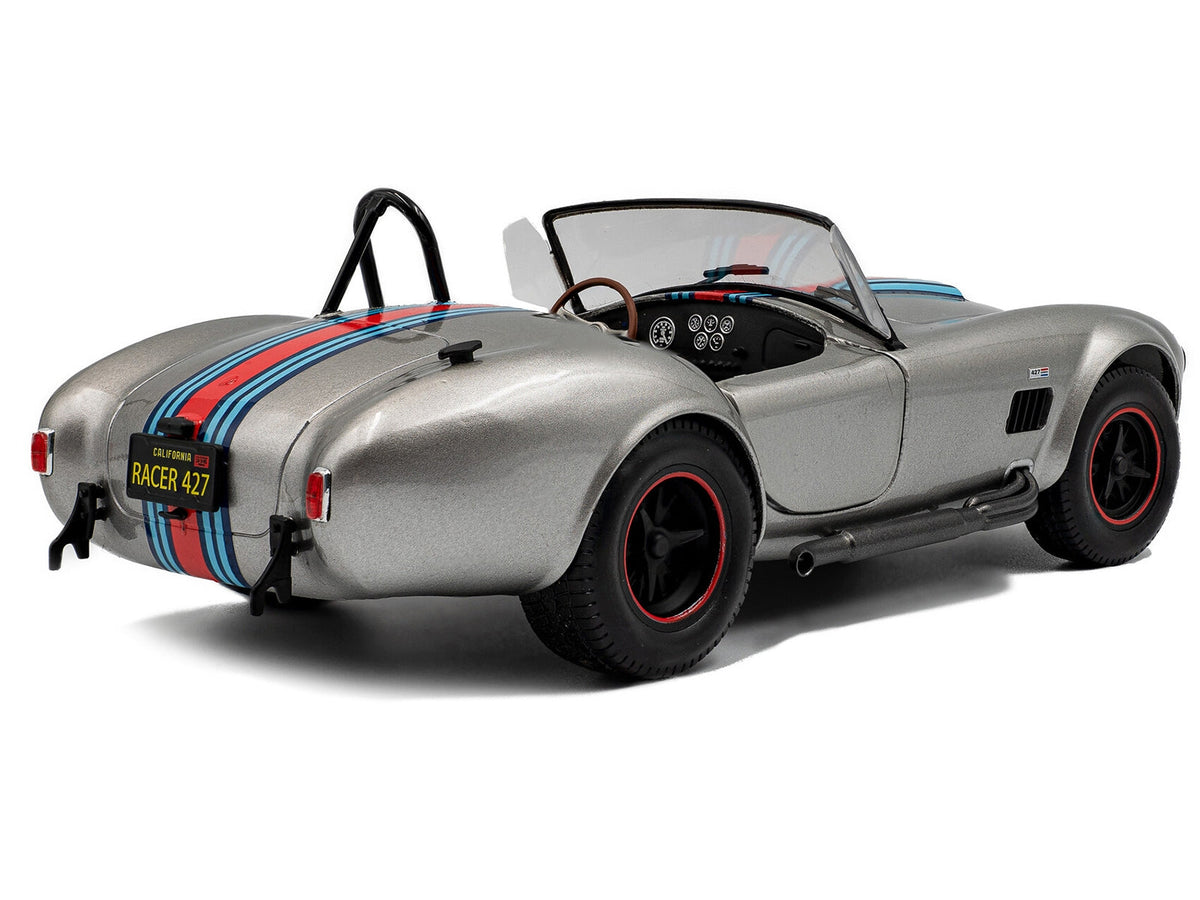 1965 Shelby Cobra 427 MKII diecast model car by Solido, gray metallic finish with racing stripes, 1/18 scale collectible.