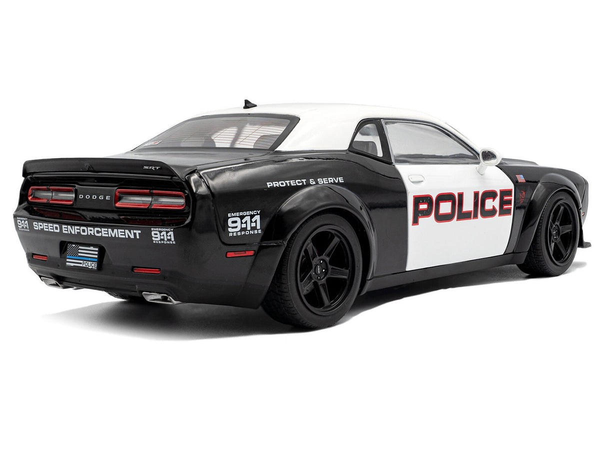Black and white 2023 Dodge Challenger Demon Police diecast model car by Solido, detailed miniature car displayed on a neutral background.