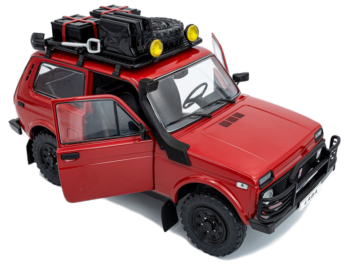 Red 1980 Lada Niva diecast model car by Solido with roof rack and accessories, 1/18 scale, detailed miniature vehicle.