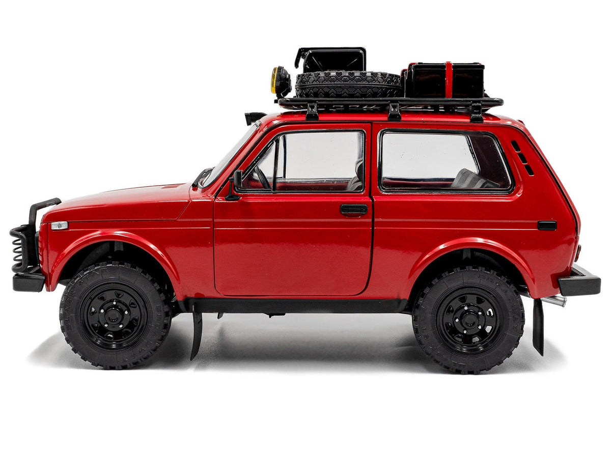 Red 1980 Lada Niva diecast model car with roof rack and accessories by Solido, detailed Miniature Motors 1/18 scale.