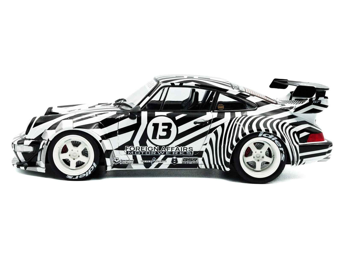 Black and white striped 1/18 diecast model car with RWB Bodykit #13 "The Zebra" by Miniature Motors, detailed miniature vehicle.