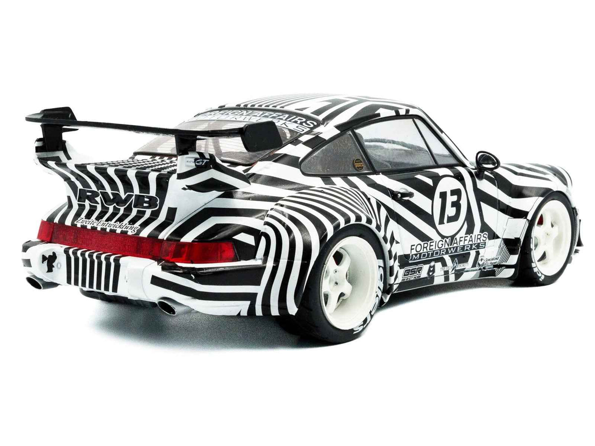 Black and white striped 1/18 diecast model car with RWB Bodykit #13 "The Zebra" by Miniature Motors, detailed miniature vehicle.