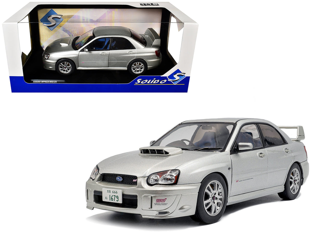 Silver 2004 Subaru Impreza WRX STI RHD 1/18 diecast model car by Solido, detailed miniature of Subaru rally car.