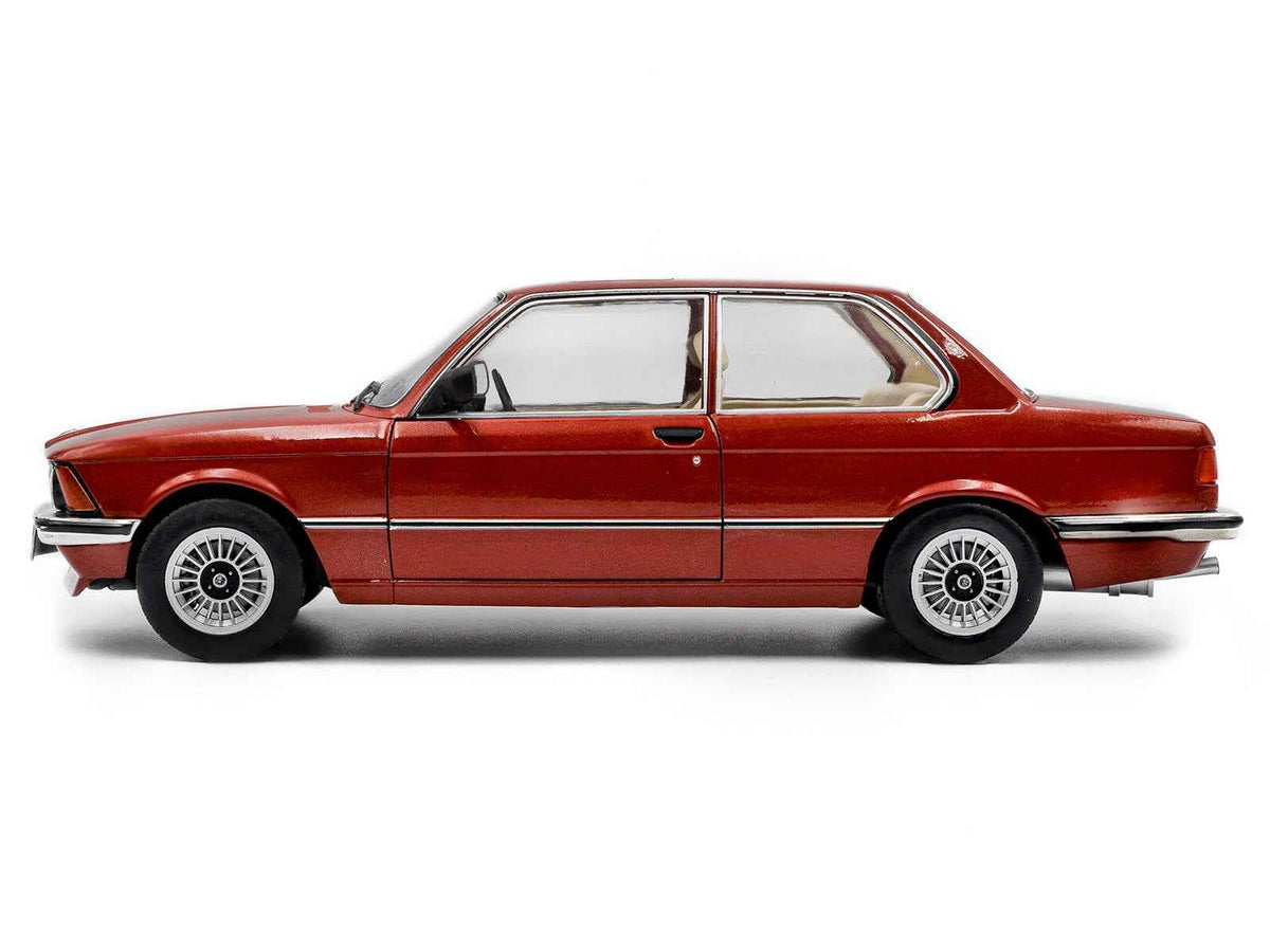 Miniature BMW 323i diecast model car in ruby red metallic, 1/18 scale by Solido, featuring detailed exterior and realistic design.