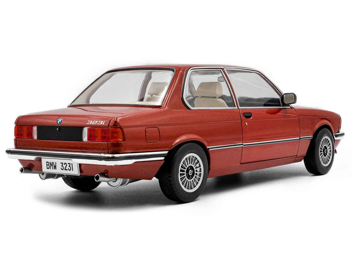Miniature BMW 323i diecast model car in ruby red metallic by Solido, detailed 1/18 scale BMW collectible toy.