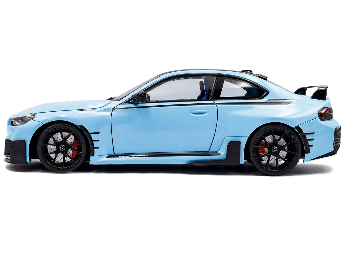 Miniature BMW M2 2024 diecast model car in Zandvoort Blue with carbon top and black stripes by Solido, 1/18 scale.