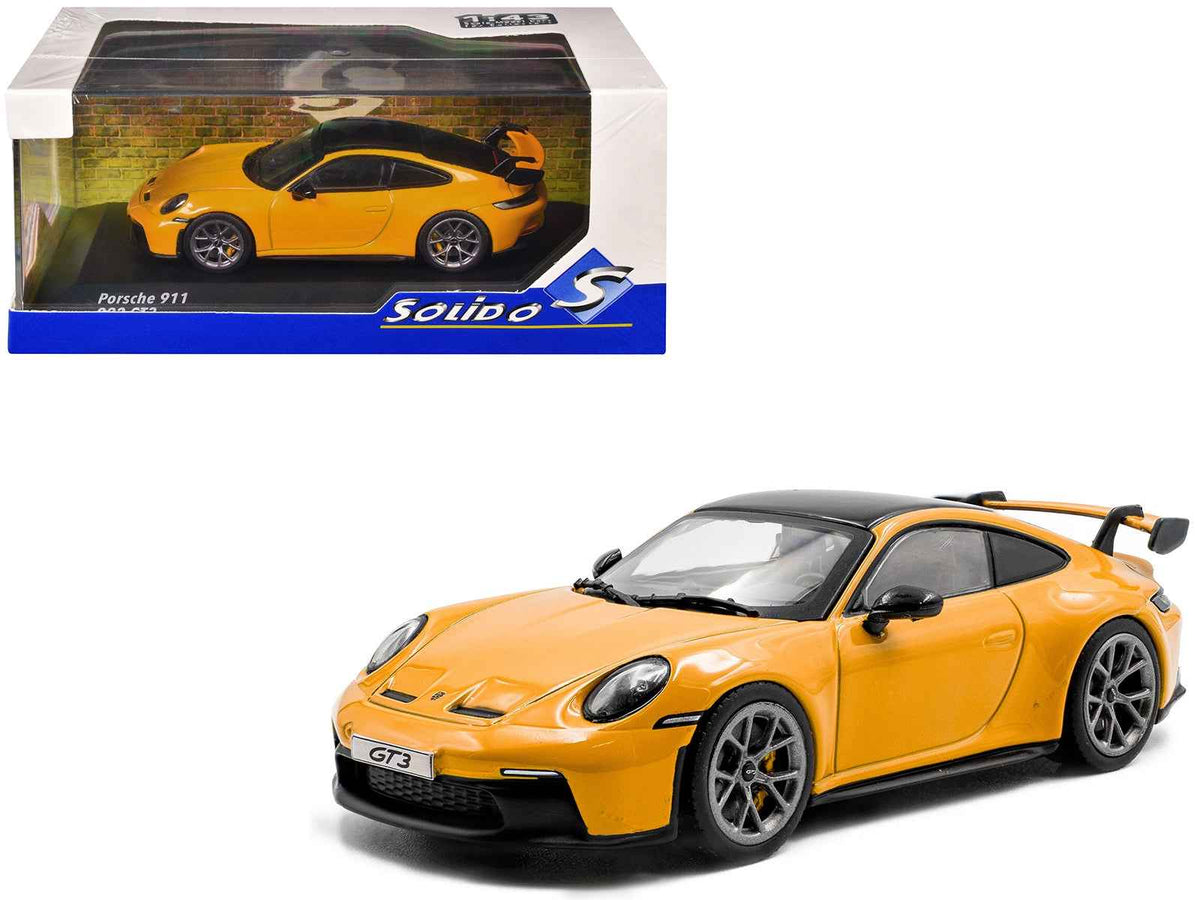 Miniature Porsche 911 (992) GT3 Signal Yellow diecast model car with black roof, made by Solido, 1/43 scale.