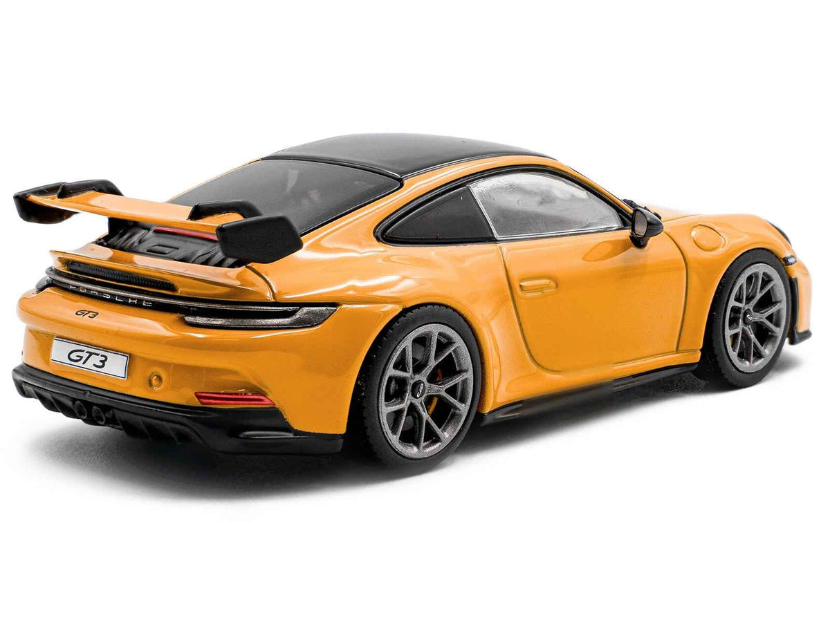 Miniature Porsche 911 (992) GT3 Signal Yellow diecast model car with black roof, 1/43 scale by Solido