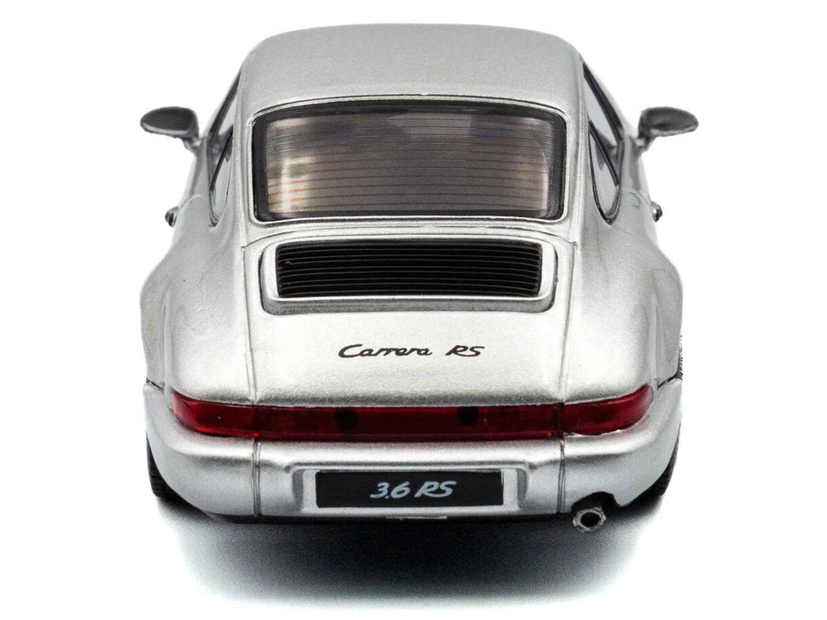 Silver metallic Porsche 911 (964) RS diecast model car with black stripes, 1/43 scale by Solido, detailed miniature vehicle.