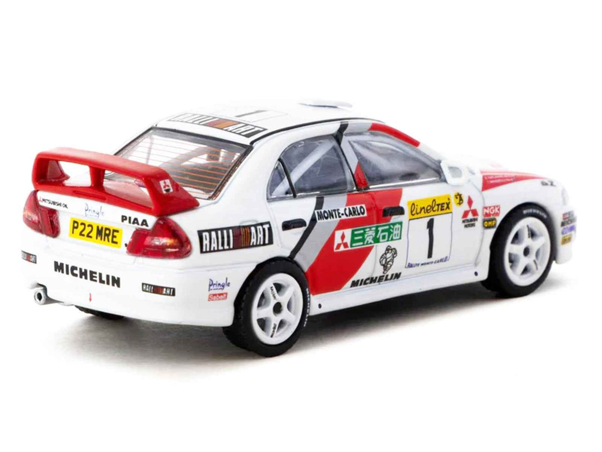 Miniature Mitsubishi Lancer Evolution IV diecast model by Tarmac Works, featuring Tommi Makinen’s 1997 Monte Carlo Rally car.