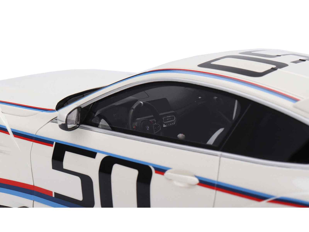 White BMW M4 3.0 CSL 1/18 scale model car with blue and red stripes by Miniature Motors, detailed view of the collectible model.