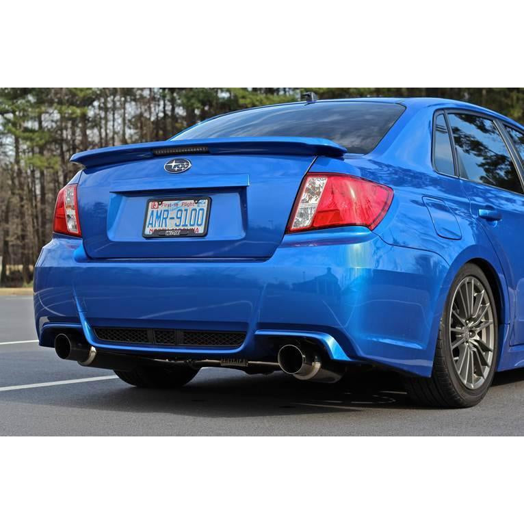 Invidia Dual N1 Burnt Titanium Tips cat back exhaust system on a Subaru WRX/STI sedan, showing dual exhaust tips and polished titanium finish.