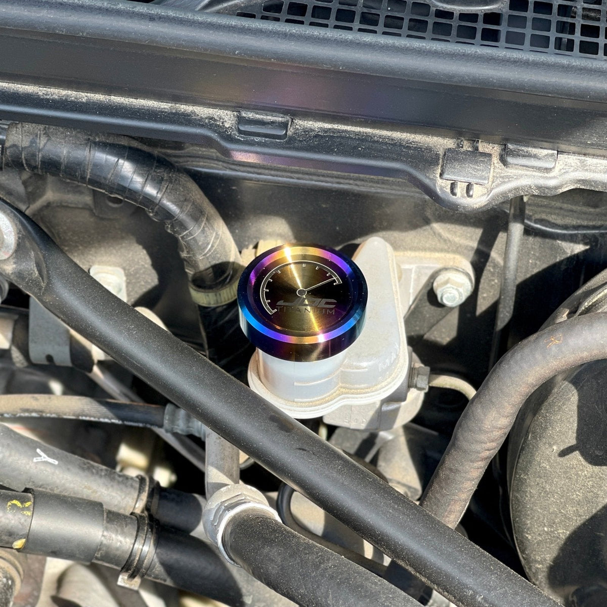 JDC Titanium clutch fluid reservoir cap cover for BRZ, FR-S, 86, and Subaru models, made of durable titanium with a sleek finish.