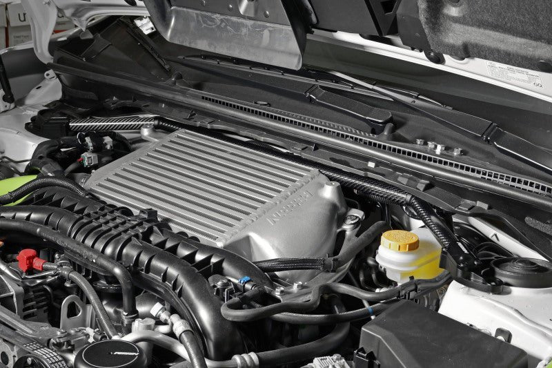 Perrin universal carbon fiber strut brace with billet feet, designed for improved chassis stability in performance vehicles.