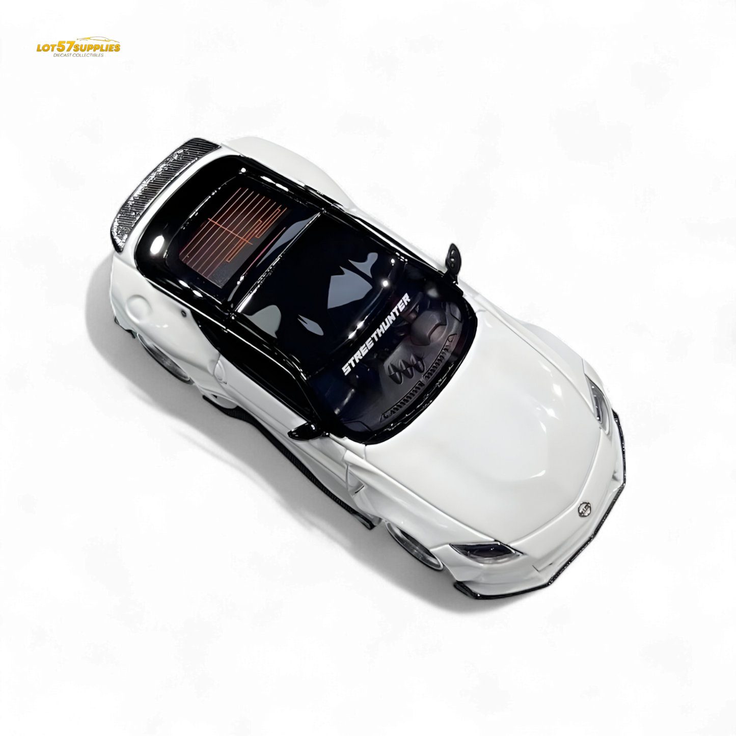 White Nissan 400Z diecast model in 1:64 scale by Lot57Supplies Diecast Shop, detailed miniature car with Nissan branding.