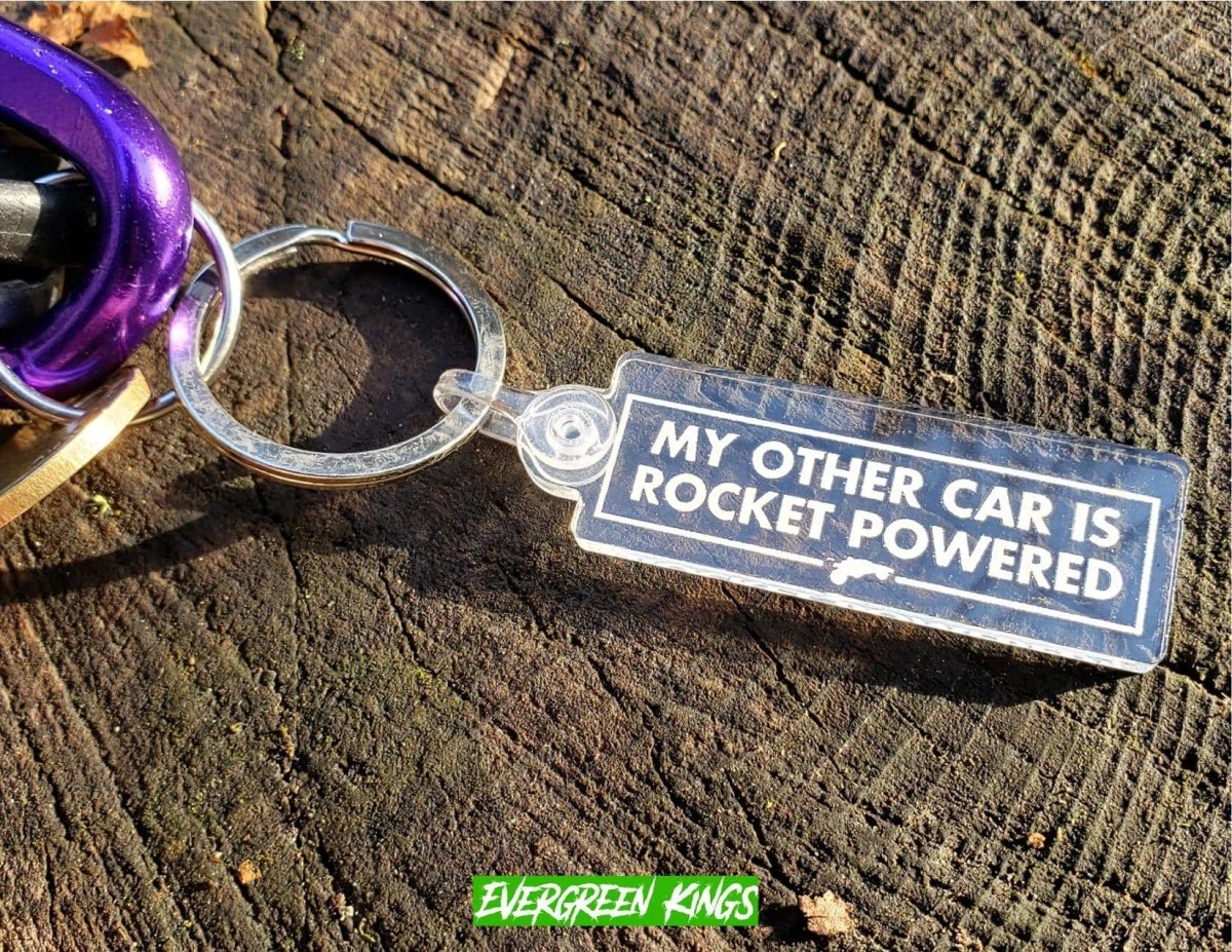 Rocket-powered car keychain by Evergreen Kings featuring a detailed miniature car with a rocket theme.