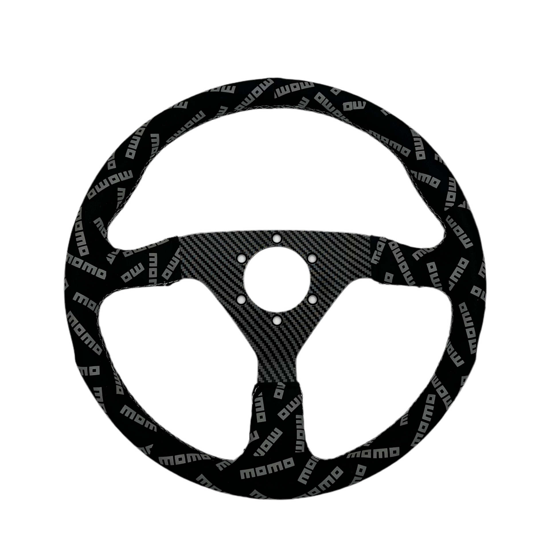 Black suede racing steering wheel with carbon center from Momo Track Style, designed for high-performance driving.