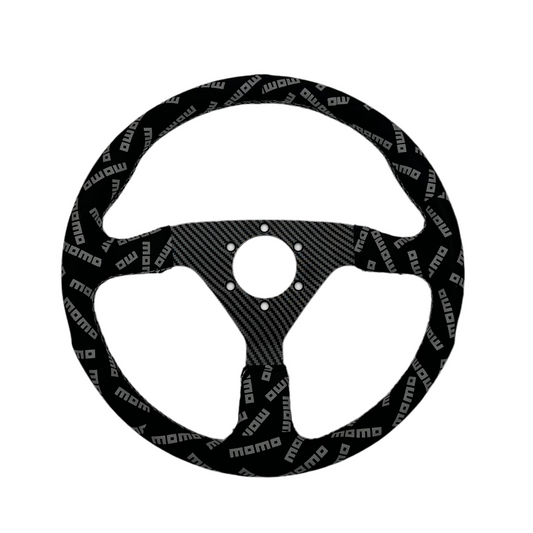 Black suede racing steering wheel with carbon center from Momo Track Style, designed for high-performance driving.