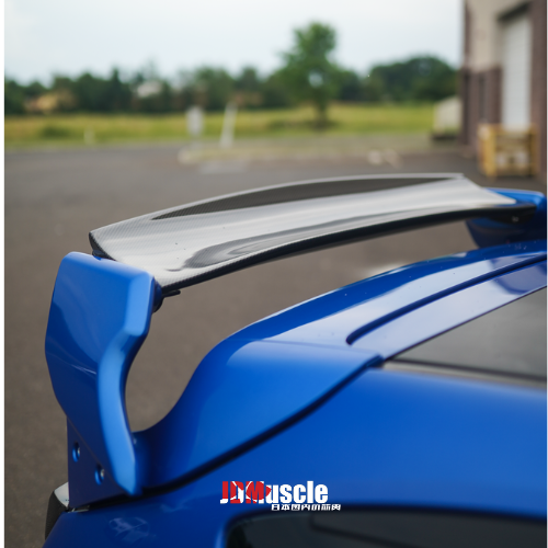 JDMuscle 08-14 WRX/STI VS Style spoiler with brake lights, ABS, paint-matched finish, and partial carbon fiber on car trunk.