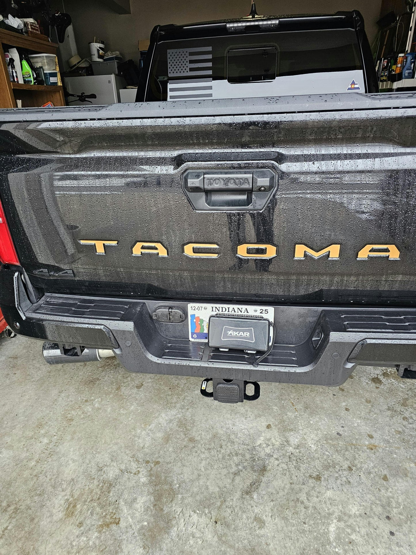 Black vinyl TACOMA tailgate inlay letters for 2024+ Tacoma, exterior automotive decal by StickerFab, shown on vehicle tailgate.