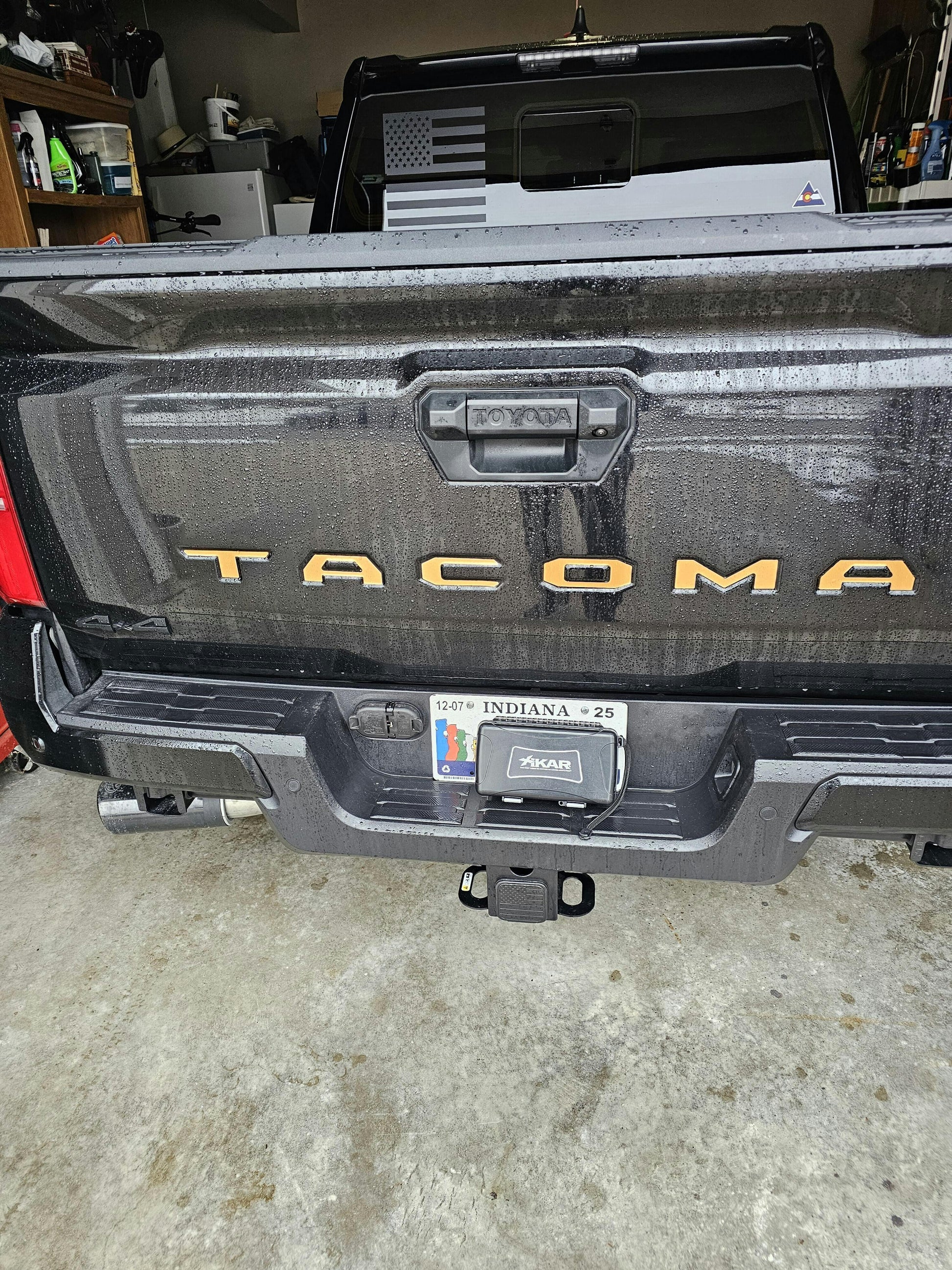 Black vinyl TACOMA tailgate inlay letters for 2024+ Tacoma, exterior automotive decal by StickerFab, shown on vehicle tailgate.