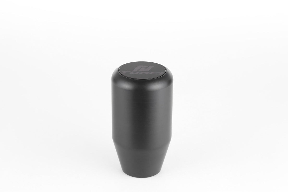 FR SPORT Tomei Duracon manual transmission shift knob with textured surface, mounted on a gear shift lever.