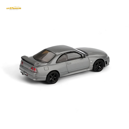 Mini GT Nissan Skyline GT-R NISMO BCNR33 diecast model in dark metal gray, 1:64 scale, detailed collectible car image.
