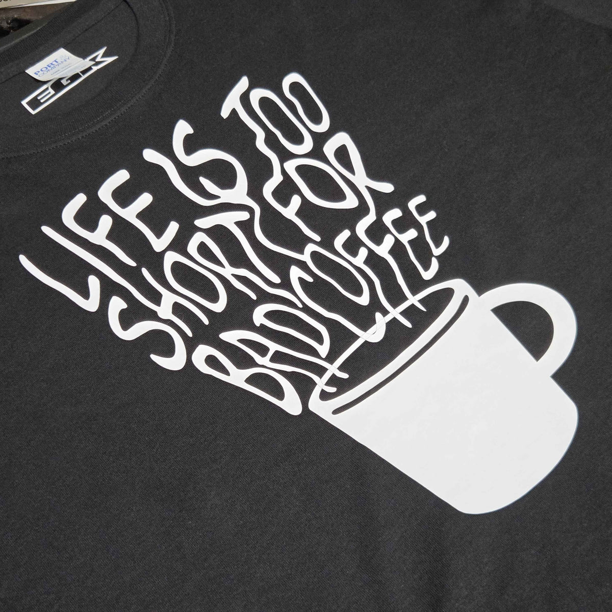 Black "Life Is Too Short For Bad Coffee" T-shirt by Evergreen Kings, casual shirt with coffee-themed slogan and comfortable fit.