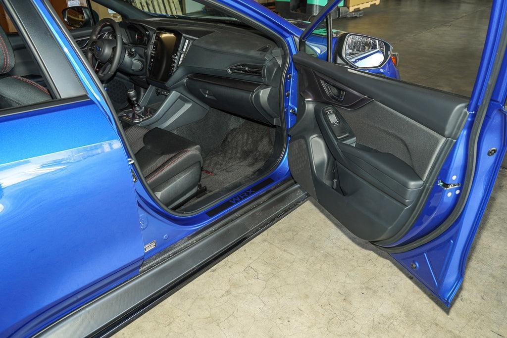3D carbon door sill accent overlay for 2015-2025 Subaru WRX/STI interior, made by StickerFab, shown on car door sill.
