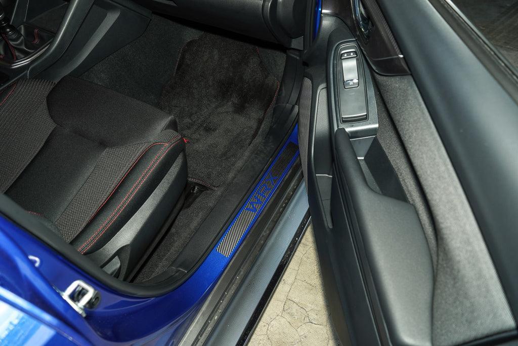 3D carbon door sill accent overlay for 2015-2025 Subaru WRX/STI interior, made by StickerFab, featuring sleek carbon fiber design