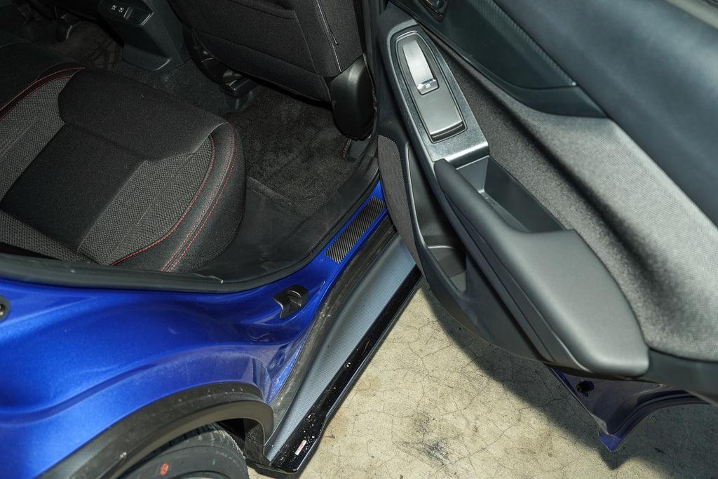 3D carbon door sill accent overlay for 2015-2025 Subaru WRX/STI interior, StickerFab brand, shown installed on car door sill.