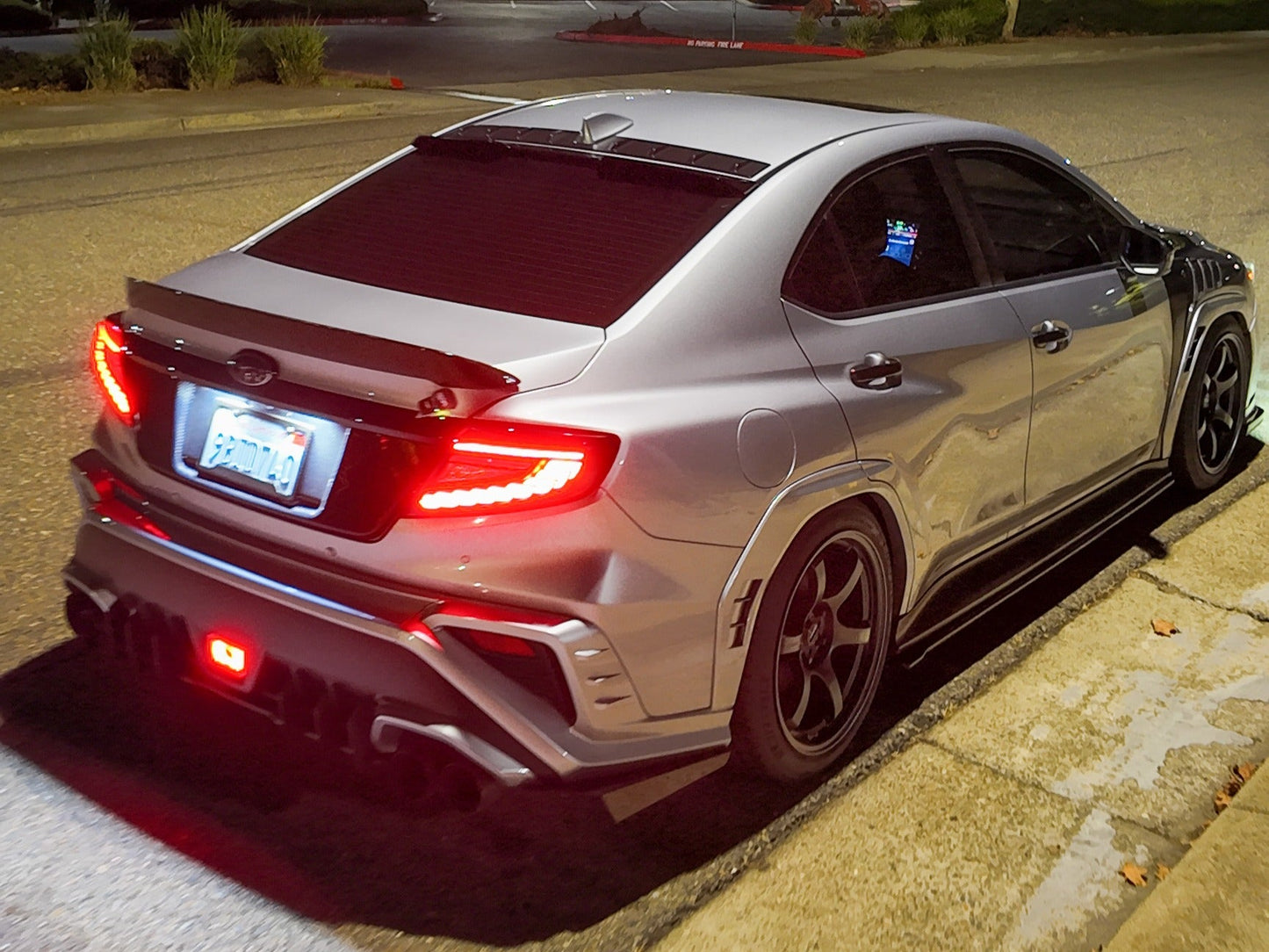OLM Phantom-Spec LED taillights with smoke lens and red optic for 2022+ Subaru WRX, showing the sleek, modern tail light design.
