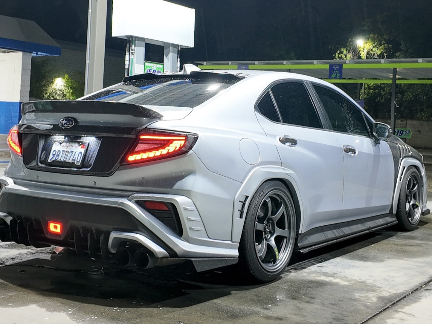 OLM Phantom-Spec LED taillights with smoke lens and white optic for 2022+ Subaru WRX, showing the sleek tail light design and illumination.