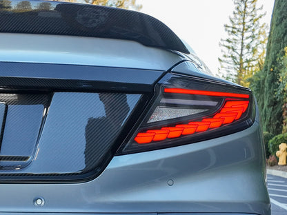 OLM Phantom-Spec LED taillights with smoke lens and white optic for 2022+ Subaru WRX, featuring sleek automotive lighting design.