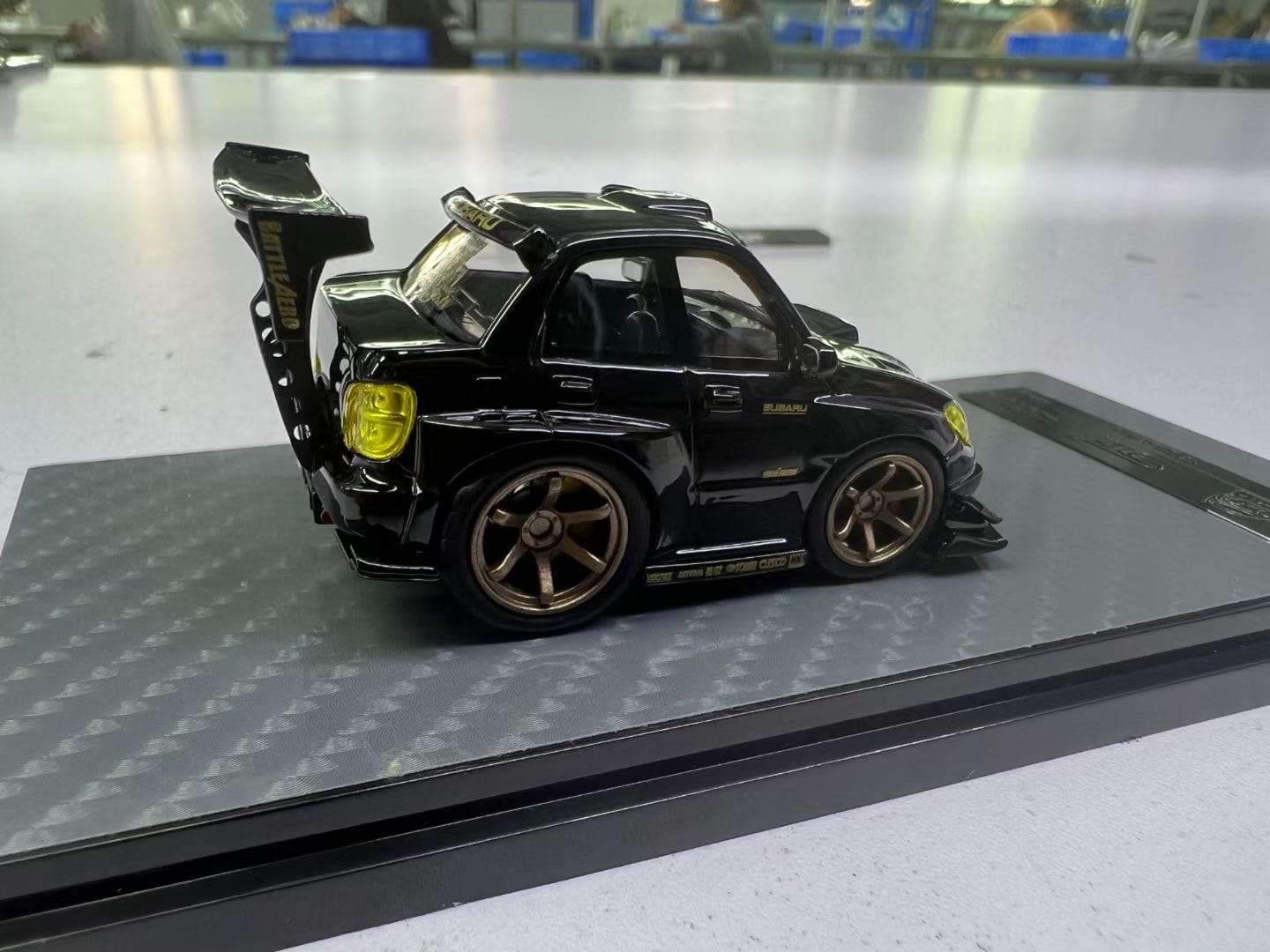 Black and gold 1:64 scale Subaru Impreza WRX STI diecast model by YM Model, featuring Voltex styling details.