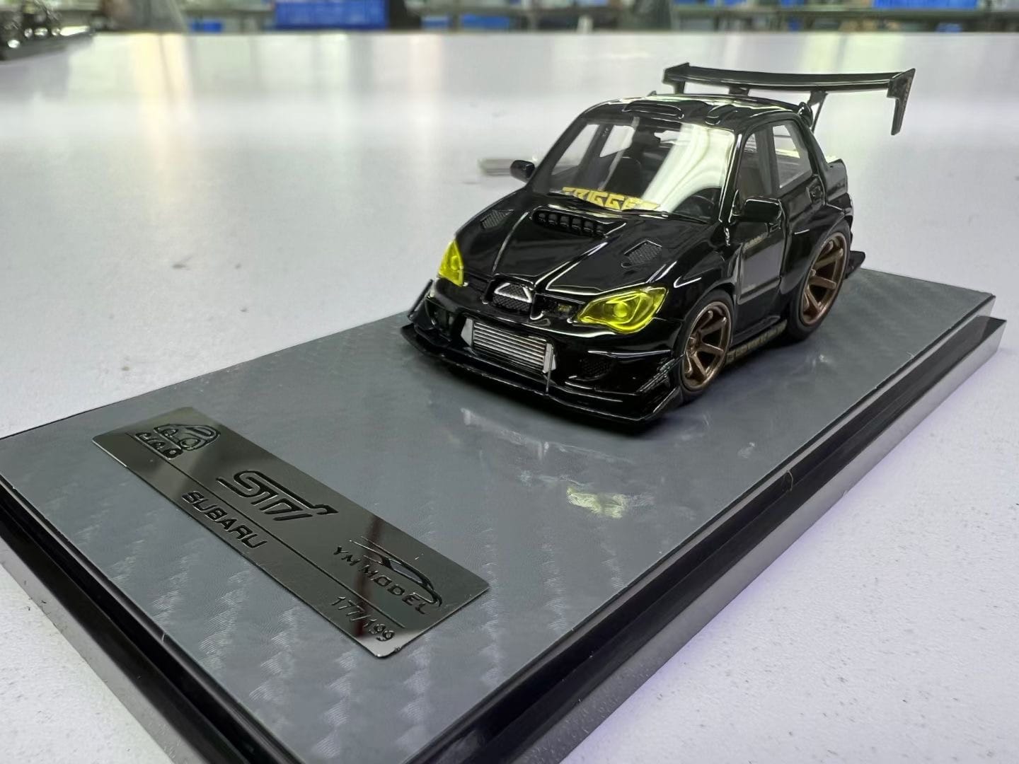 Black and gold YM Model Subaru Impreza WRX STI diecast car, 1:64 scale by Lot57Supplies Diecast Shop, detailed model vehicle.