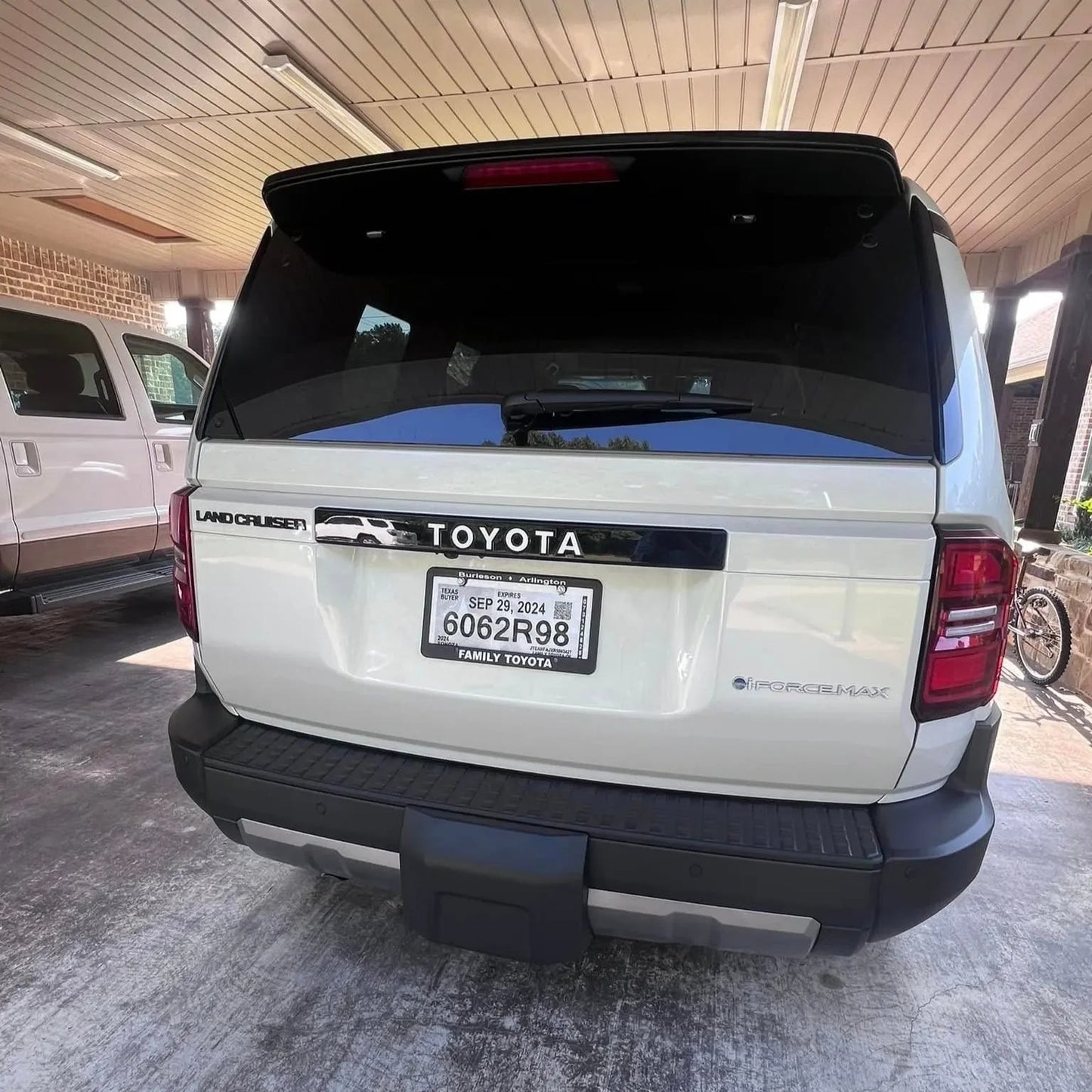Toyota Land Cruiser 2024+ rear tailgate emblem overlays by StickerFab, featuring stylish chrome emblems on a vehicle tailgate.