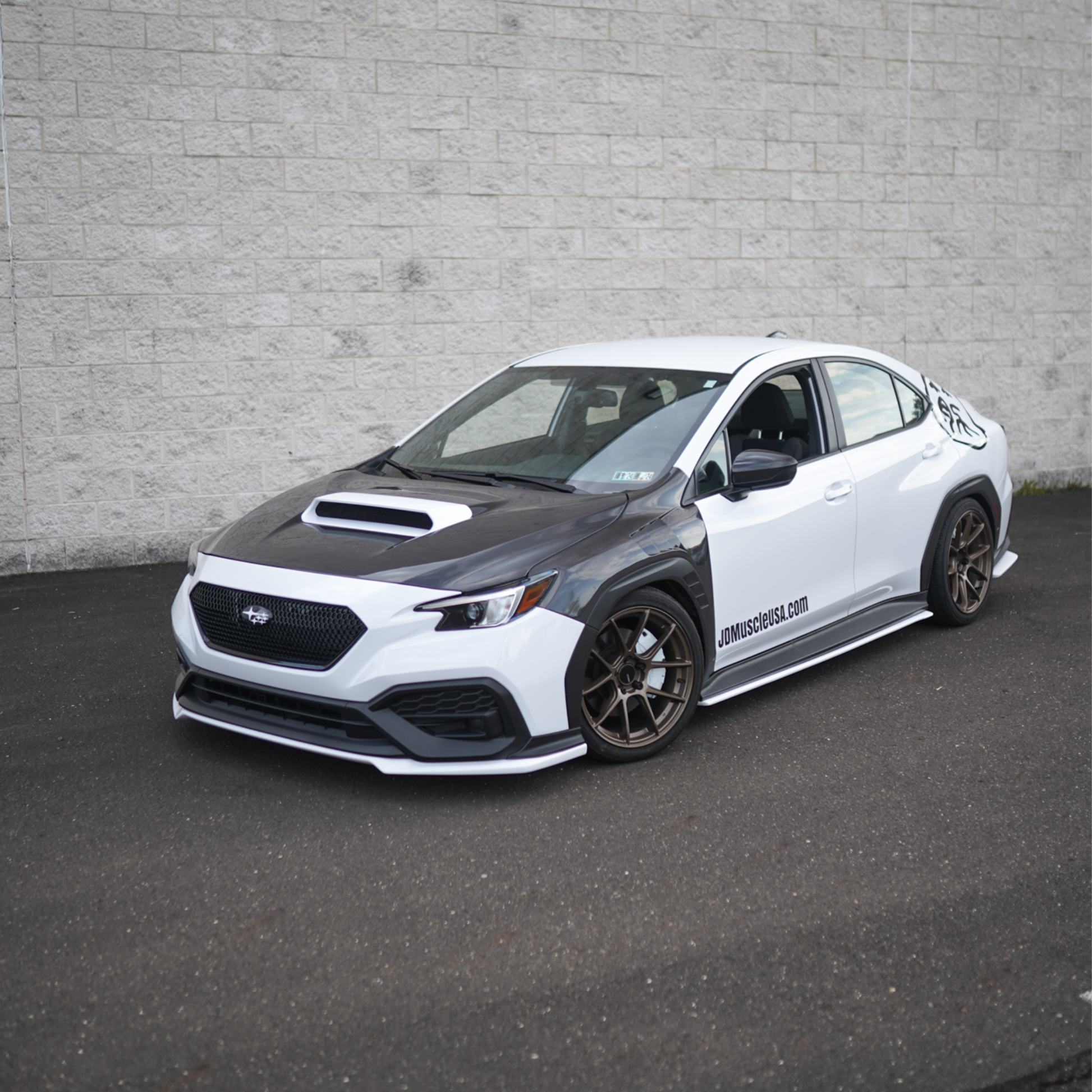 JDMuscle Tanso carbon fiber hood for Subaru WRX 22-25, OEM+ style 2-piece design with sleek finish and vent details.