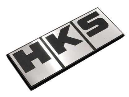HKS Silver Block Logo emblem decal for cars, featuring the HKS brand name in bold silver lettering on a sleek background.