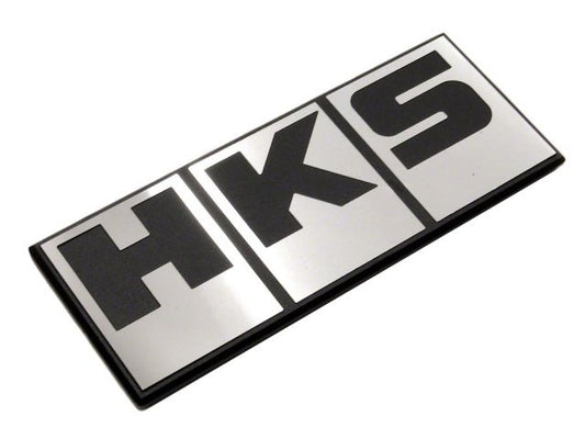 HKS Silver Block Logo emblem decal for cars, featuring the HKS brand name in bold silver lettering on a sleek background.