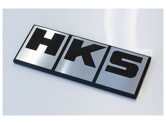 Silver HKS diamond cut aluminum emblem for decals and emblems, 89mm by 36mm, with a sleek metallic finish.