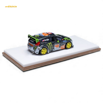 Miniature Ford Fiesta diecast model in Gymkhana livery, 1:64 scale, featuring detailed decals and vibrant racing colors.