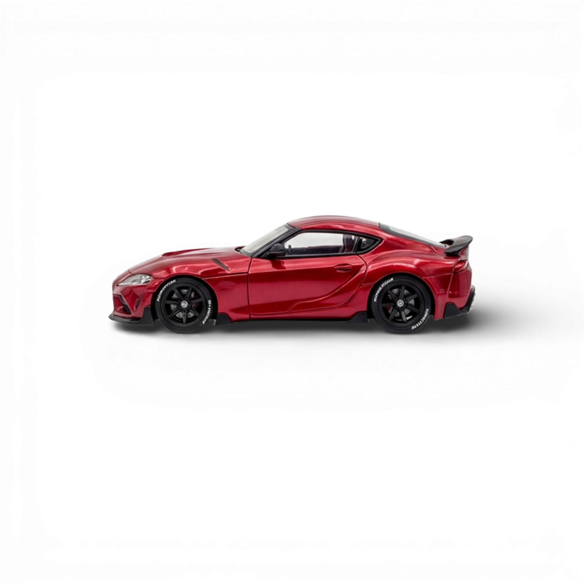 Red Toyota Supra GR diecast car model in 1:64 scale by Lot57Supplies Diecast Shop, showcasing metallic red finish and detailed design.
