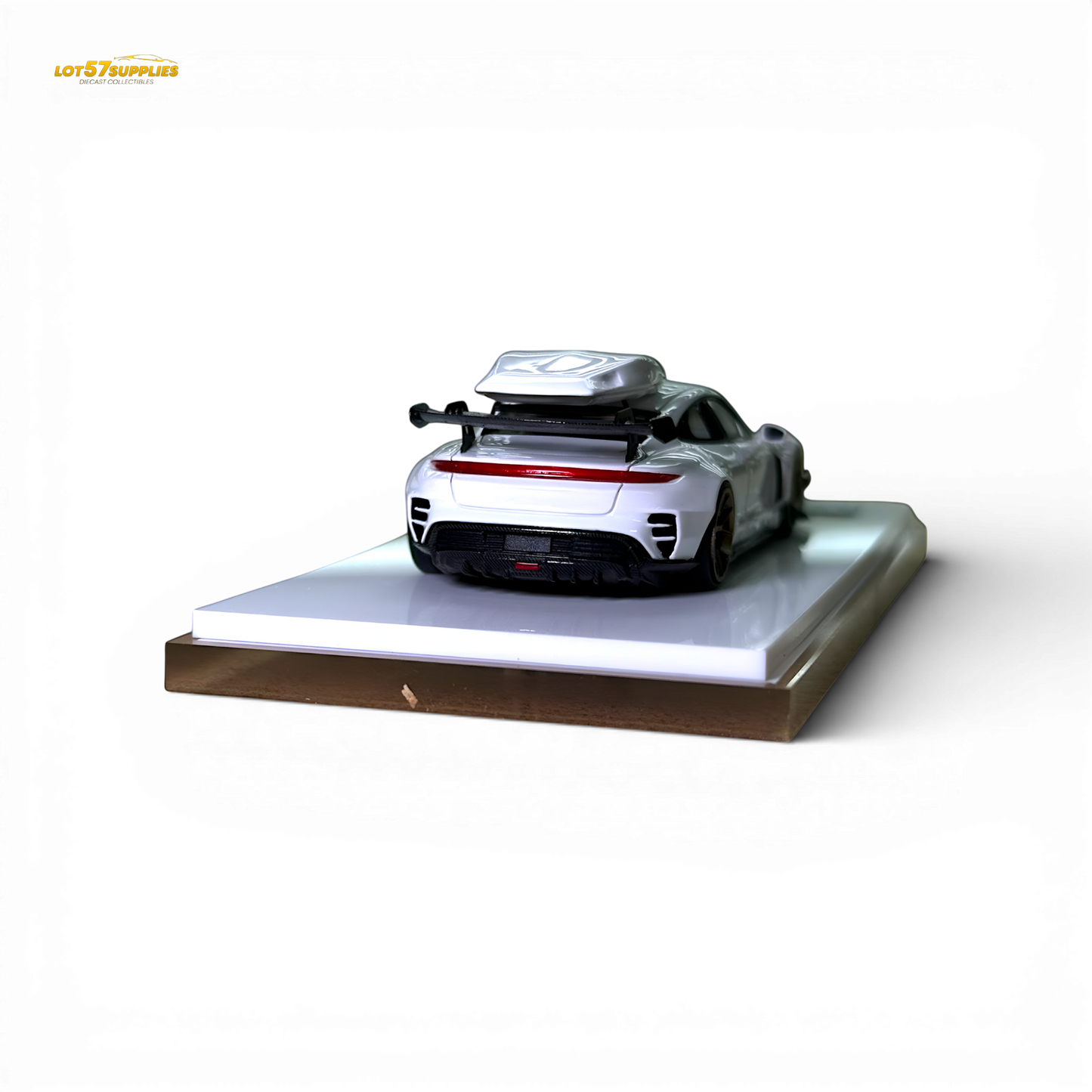 White Porsche Taycan diecast model with roof box, 1:64 scale, detailed miniature car in a realistic pose.