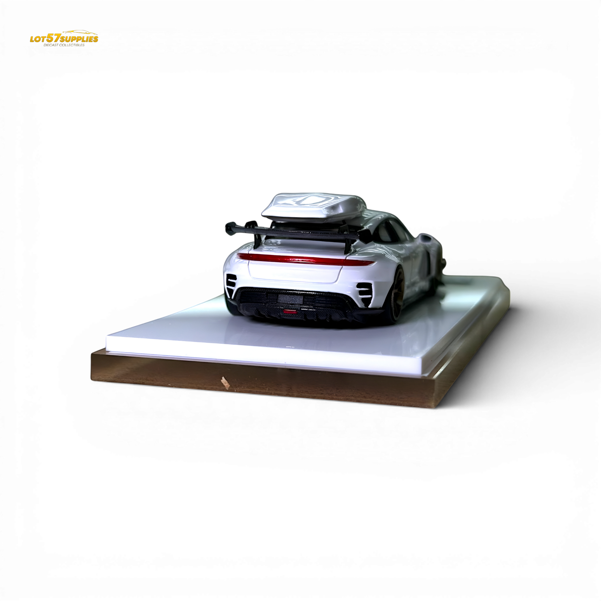 White Porsche Taycan diecast model with roof box, 1:64 scale, detailed miniature car in a realistic pose.