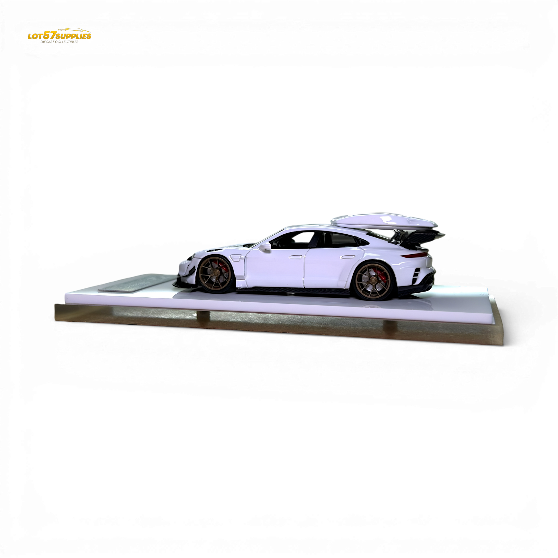 White Porsche Taycan 1:64 diecast model with roof box, detailed miniature car in a realistic pose