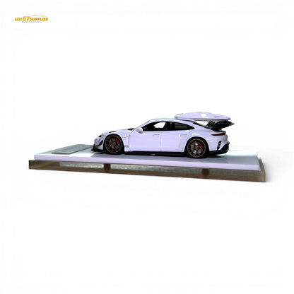 White Porsche Taycan 1:64 diecast model with roof box, detailed miniature car in a realistic pose