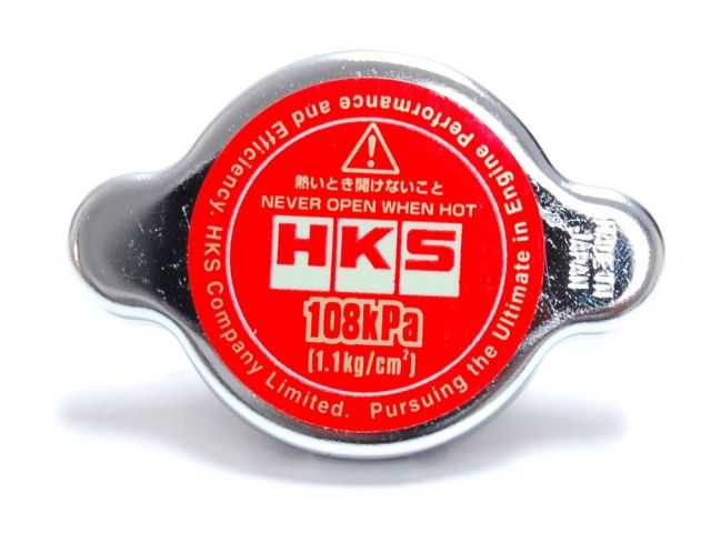 HKS D1 Limited Edition radiator cap by FR SPORT, 1.1 kg/cm² pressure, showing the cap on a vehicle radiator.