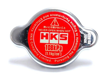 HKS D1 Limited Edition radiator cap by FR SPORT, 1.1 kg/cm² pressure, showing the cap on a vehicle radiator.