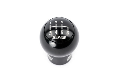 FR SPORT AMS Performance Subaru WRX/STi 6-speed billet shift knob with red, black, and gunmetal caps on a manual transmission.